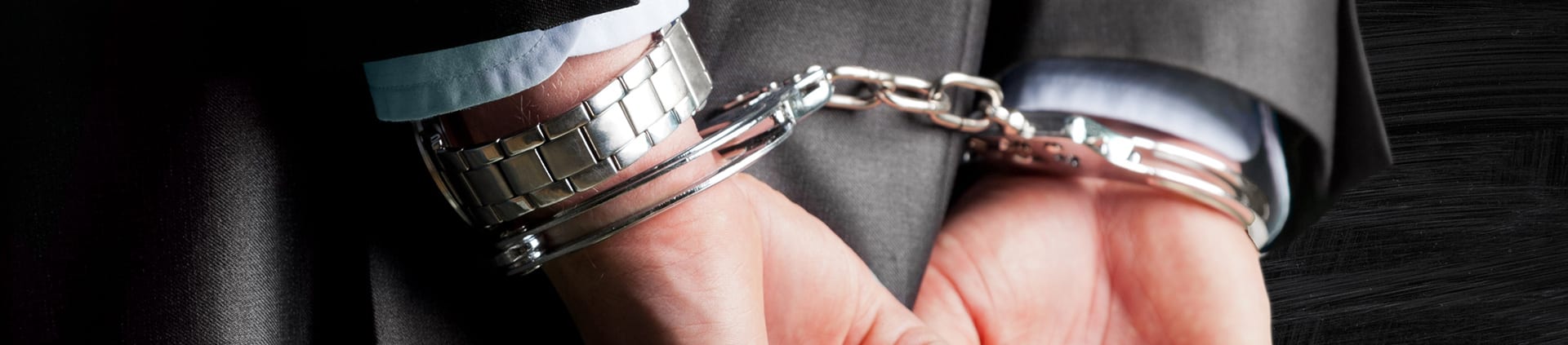 handcuffed due to white collar crime